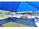 Picnic tables under a blue shade sail at 4228 Central Sarasota Pkwy # 1013, Sarasota, FL 34238