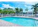 Refreshing community pool with lounge chairs and patio area at 4228 Central Sarasota Pkwy # 1013, Sarasota, FL 34238