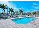 Inviting community pool with lounge chairs and surrounding palm trees at 4228 Central Sarasota Pkwy # 1013, Sarasota, FL 34238