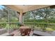 Enjoy the outdoors in this screened patio featuring a small table and chairs at 4228 Central Sarasota Pkwy # 1013, Sarasota, FL 34238