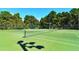 Two tennis courts with nets and green surface at 4228 Central Sarasota Pkwy # 1013, Sarasota, FL 34238