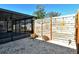 Backyard with covered patio, wood fence, and gravel landscaping at 4284 Watova Ave, North Port, FL 34286