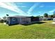 Backyard view of home with covered patio and fence at 4284 Watova Ave, North Port, FL 34286