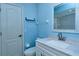 Bathroom with light blue walls, a vanity with marble top, and shower at 4284 Watova Ave, North Port, FL 34286