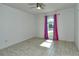 Bright bedroom with tile floors, ceiling fan, and arched window at 4284 Watova Ave, North Port, FL 34286