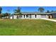 Gray house with a gray roof, arched windows, and a well-manicured lawn at 4284 Watova Ave, North Port, FL 34286