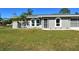 Newly renovated gray house with a lush green lawn and driveway at 4284 Watova Ave, North Port, FL 34286