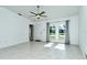 Living room with tile floors, arched windows, and ceiling fan at 4284 Watova Ave, North Port, FL 34286