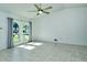 Spacious living room with tile floors, arched windows, and ceiling fan at 4284 Watova Ave, North Port, FL 34286