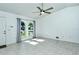 Living room with tile floors, arched windows, and ceiling fan at 4284 Watova Ave, North Port, FL 34286