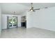 Living room with tile floors, a view of the kitchen, and ceiling fan at 4284 Watova Ave, North Port, FL 34286