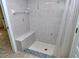 Shower stall with floral tile and built-in seat at 4284 Watova Ave, North Port, FL 34286