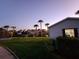 Landscaped backyard with canal views at sunset at 4430 Wynkoop Cir, Port Charlotte, FL 33948