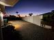 Backyard with gravel and a white fence at dusk at 4430 Wynkoop Cir, Port Charlotte, FL 33948