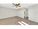Light and airy bedroom with wood-look floors and access to bathroom at 4430 Wynkoop Cir, Port Charlotte, FL 33948