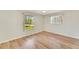 Bedroom with a large window and light wood floors at 4430 Wynkoop Cir, Port Charlotte, FL 33948