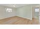 Bedroom with ceiling fan, wood-look flooring, and access to bathroom at 4430 Wynkoop Cir, Port Charlotte, FL 33948