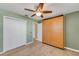 Bedroom featuring wood flooring, built-in wardrobe and ceiling fan at 4430 Wynkoop Cir, Port Charlotte, FL 33948