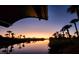 Sunset view over canal with palm trees at 4430 Wynkoop Cir, Port Charlotte, FL 33948