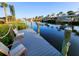 Relaxing waterfront dock with seating, offering picturesque canal views at 4430 Wynkoop Cir, Port Charlotte, FL 33948