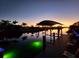 Covered boat dock with seating at sunset at 4430 Wynkoop Cir, Port Charlotte, FL 33948