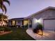 Single story home with gray siding, solar panels, landscaped yard at 4430 Wynkoop Cir, Port Charlotte, FL 33948