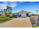 Single-story home with a two-car garage and landscaped yard at 4430 Wynkoop Cir, Port Charlotte, FL 33948
