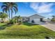 Single-story home with landscaped yard and two-car garage at 4430 Wynkoop Cir, Port Charlotte, FL 33948