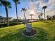 Lush lawn, palm trees, & pelican statue; waterfront view at 4430 Wynkoop Cir, Port Charlotte, FL 33948