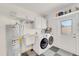 Laundry room with washer, dryer, utility sink, and ample cabinet space at 4430 Wynkoop Cir, Port Charlotte, FL 33948