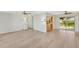 Open concept living and kitchen area with light wood floors at 4430 Wynkoop Cir, Port Charlotte, FL 33948
