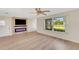 Living room featuring a fireplace and large window at 4430 Wynkoop Cir, Port Charlotte, FL 33948