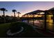 Enclosed pool and patio area with water features, at dusk at 4430 Wynkoop Cir, Port Charlotte, FL 33948