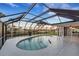 Relaxing kidney-shaped pool with screened enclosure and water view at 4430 Wynkoop Cir, Port Charlotte, FL 33948