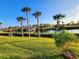 Boat dock, lush landscaping, and calm water at 4430 Wynkoop Cir, Port Charlotte, FL 33948
