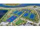 Aerial view of community tennis courts, a basketball court, and a putting green at 4886 Seafoam Trl, Bradenton, FL 34211