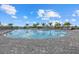 Large community swimming pool with ample lounge chairs and palm trees, perfect for relaxation and recreation at 4886 Seafoam Trl, Bradenton, FL 34211