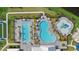 Aerial view of a community pool area featuring an oversized pool, splashpad, and lounging areas at 4886 Seafoam Trl, Bradenton, FL 34211