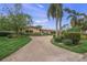 Single-Gathering home with a brick driveway and lush landscaping at 523 N Spoonbill Dr, Sarasota, FL 34236