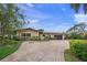 Single-story home exterior with a brick driveway at 523 N Spoonbill Dr, Sarasota, FL 34236