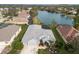 Gray house on a lakefront lot with other homes in the neighborhood at 5383 Creekside Trl, Sarasota, FL 34243