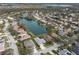 Aerial view of a neighborhood featuring a lake and various houses, including a gray home at 5383 Creekside Trl, Sarasota, FL 34243