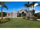 Gray house with two-car garage, landscaping, and palm trees at 5383 Creekside Trl, Sarasota, FL 34243