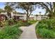 Paved pathway winds through lush landscaping, leading to the community buildings at 5889 Canal Dr # I4, Bradenton, FL 34207