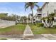 Community walkway with lush landscaping and pool access at 5889 Canal Dr # I4, Bradenton, FL 34207
