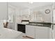 White kitchen with appliances and granite countertops at 5889 Canal Dr # I4, Bradenton, FL 34207