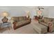 Living room with sofa and ottoman, near dining area at 5889 Canal Dr # I4, Bradenton, FL 34207