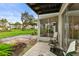 Private screened patio with seating area overlooking lawn at 5889 Canal Dr # I4, Bradenton, FL 34207