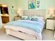 Bright bedroom with a king-size bed, ensuite bathroom access, and coastal decor at 6014 Fiore Dr, Bradenton, FL 34208