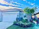 Single-story home with a white garage door and nicely landscaped front at 6014 Fiore Dr, Bradenton, FL 34208